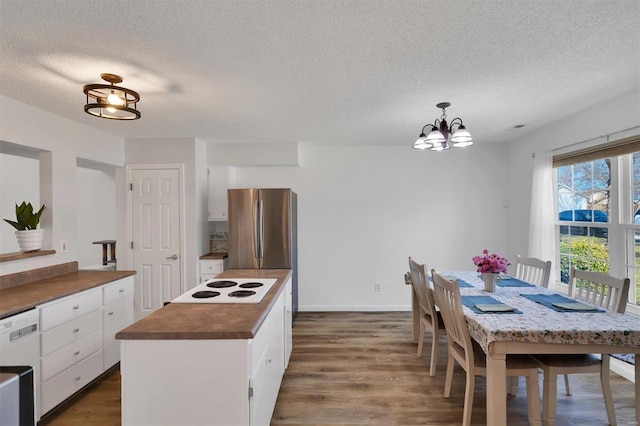 kitchen with a textured ceiling, a chandelier, white appliances, white cabinetry, and dark wood-style floors