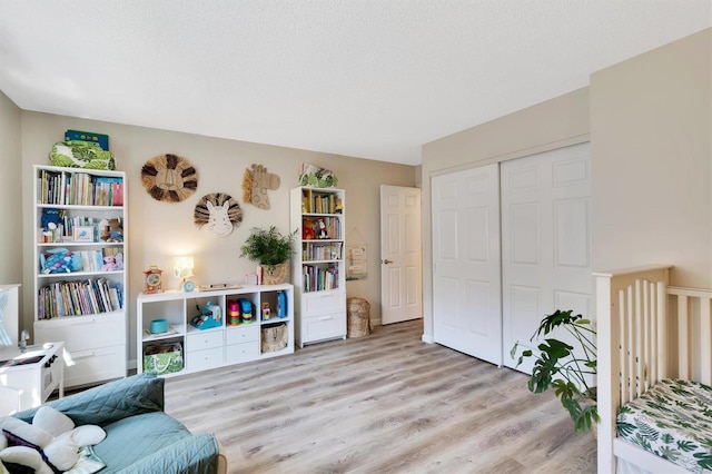 sitting room featuring a textured ceiling and wood finished floors