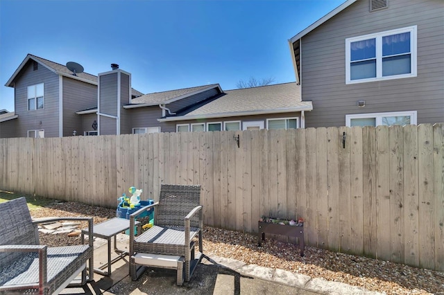 view of patio featuring fence