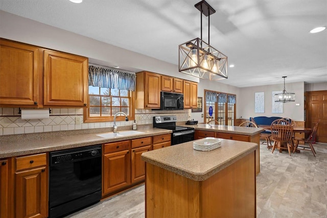 kitchen with brown cabinets, a notable chandelier, black appliances, a sink, and a peninsula