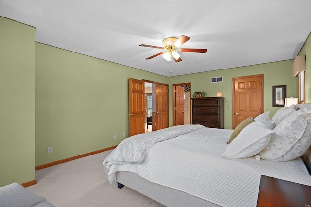 bedroom with a ceiling fan, baseboards, visible vents, and carpet floors