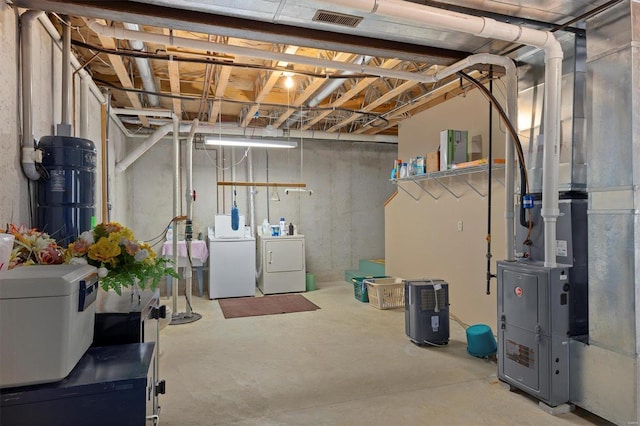 unfinished basement with visible vents and separate washer and dryer