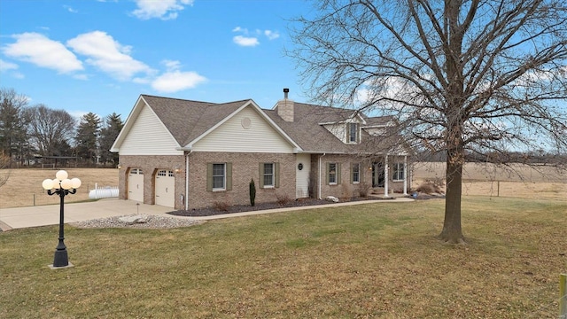 view of front of property with roof with shingles, a chimney, concrete driveway, a front lawn, and brick siding