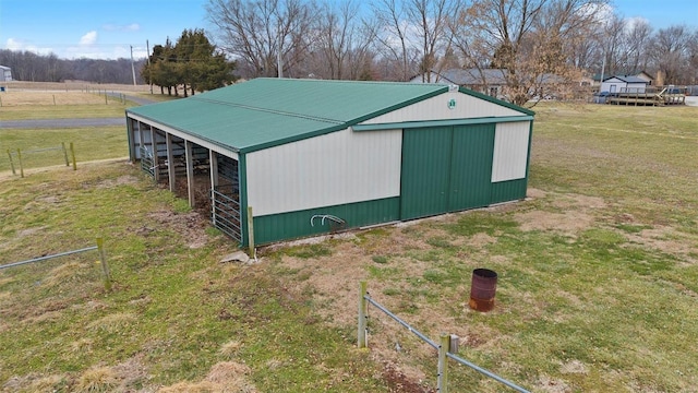 view of pole building featuring a yard and fence