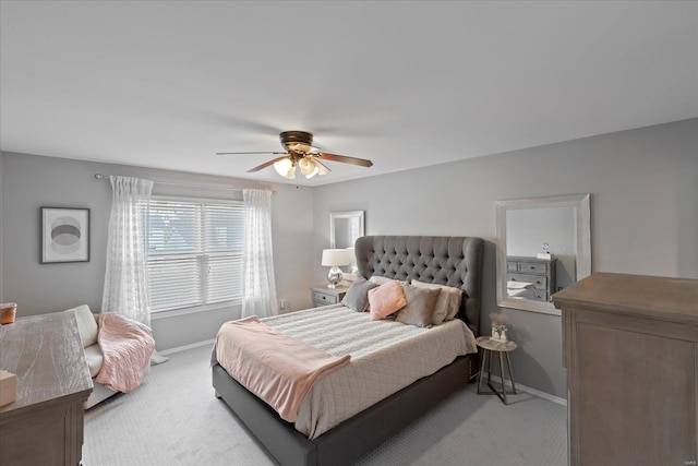 bedroom featuring baseboards, a ceiling fan, and light colored carpet