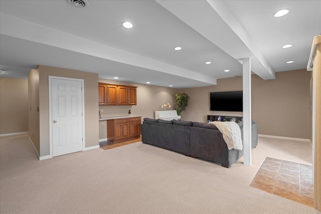 living area with light carpet, baseboards, and recessed lighting