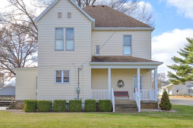 view of front of house with a porch and a front yard