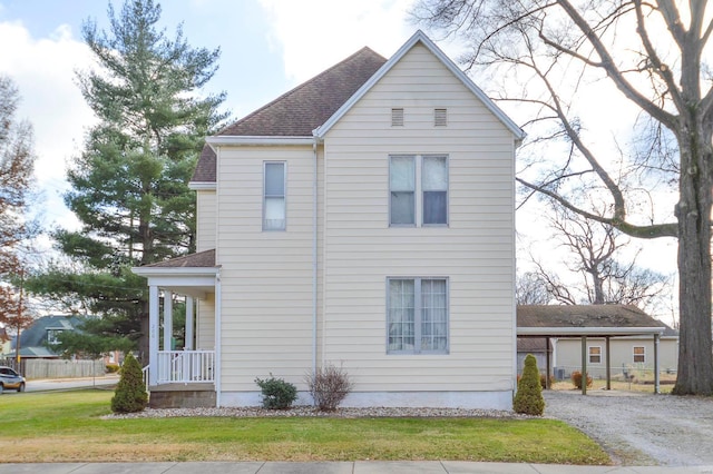 view of property exterior with a porch and a yard