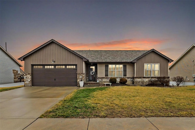 view of front of home with a yard and a garage