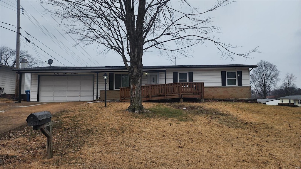 ranch-style house with a wooden deck, a garage, and a front lawn