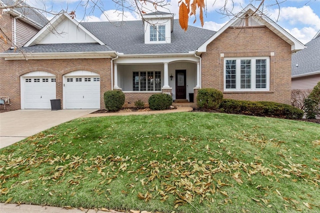 view of front of house featuring a garage, a front lawn, and a porch