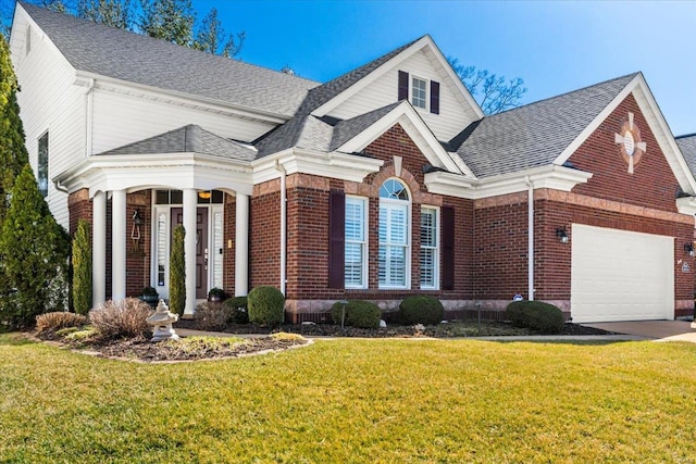 view of front facade featuring brick siding, a shingled roof, and a front yard