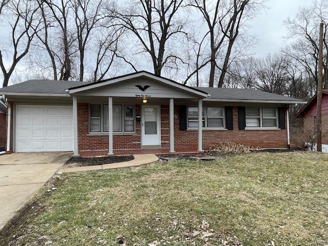 single story home with a garage and a front yard