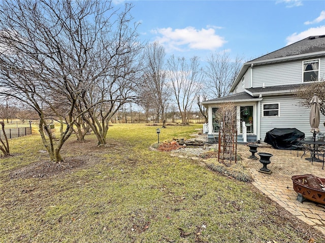 view of yard with a patio area, an outdoor fire pit, and fence