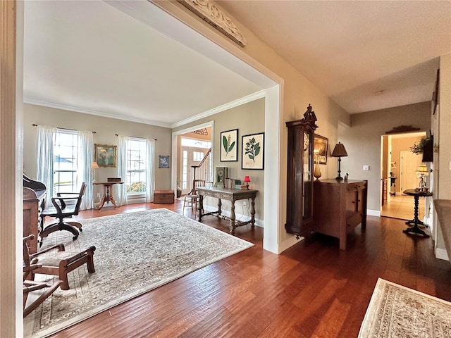 foyer entrance featuring ornamental molding, dark wood finished floors, and baseboards