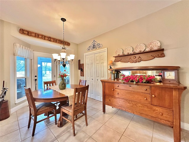 dining room with baseboards, a chandelier, and light tile patterned flooring