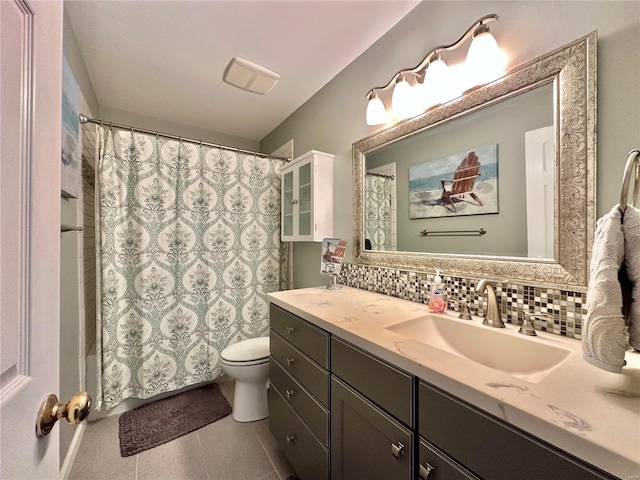 full bathroom with tile patterned flooring, toilet, vanity, and decorative backsplash