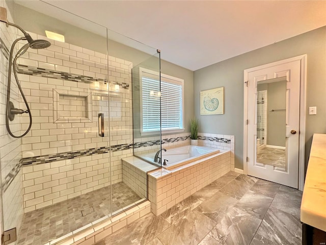 bathroom with a stall shower, vanity, and a bath