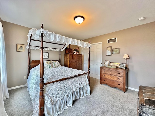 carpeted bedroom with visible vents and baseboards