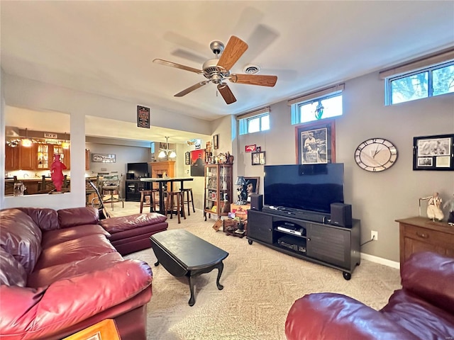 living area with carpet, baseboards, and a wealth of natural light