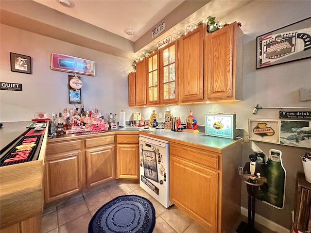 bar featuring bar, white dishwasher, and light tile patterned flooring