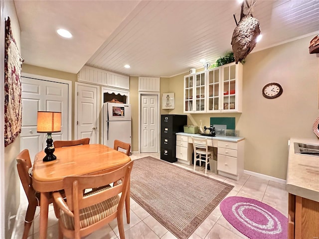 dining room featuring light tile patterned floors, recessed lighting, baseboards, and built in study area