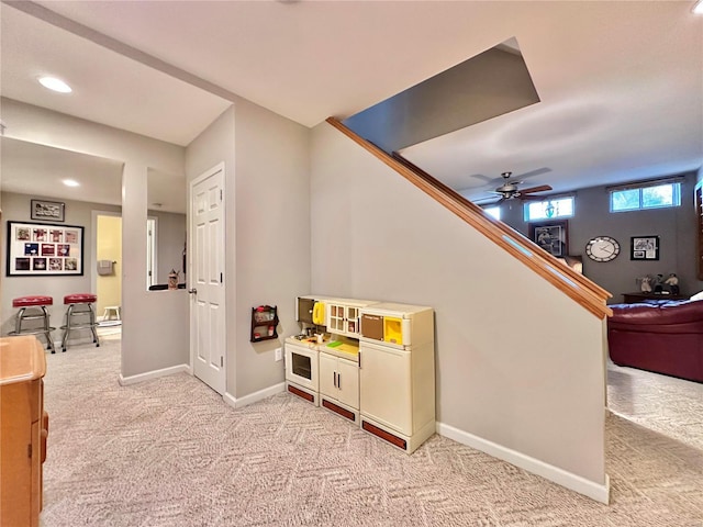 rec room with recessed lighting, light colored carpet, and baseboards