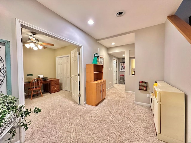 hallway with baseboards, recessed lighting, visible vents, and light colored carpet