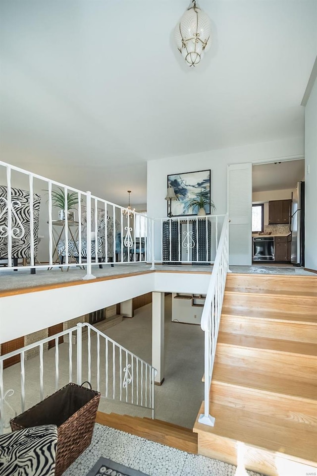 stairs featuring an inviting chandelier