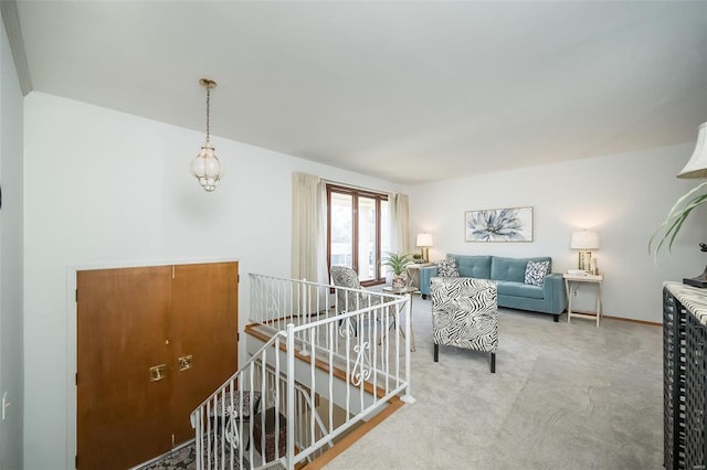 corridor featuring an upstairs landing and carpet floors