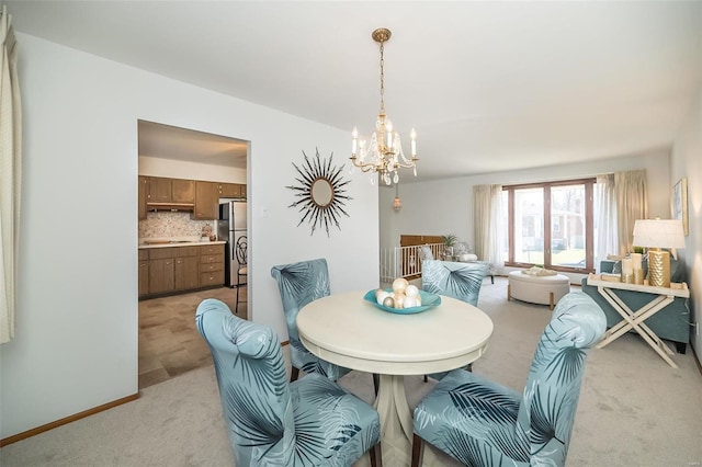 dining area with baseboards, light carpet, and a notable chandelier