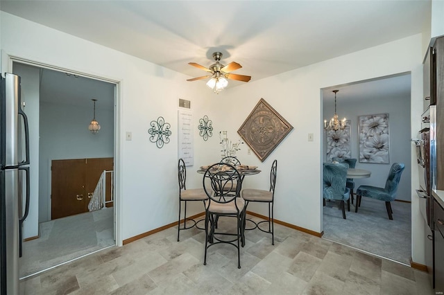 dining space with visible vents, baseboards, and ceiling fan with notable chandelier