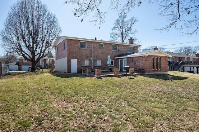 back of property featuring a patio area, brick siding, a chimney, and a lawn