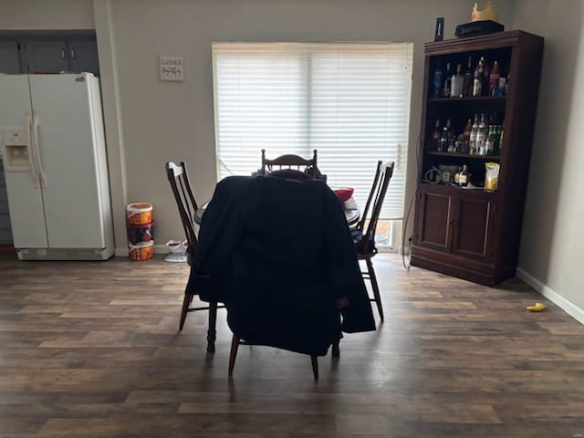 dining area featuring dark wood-type flooring