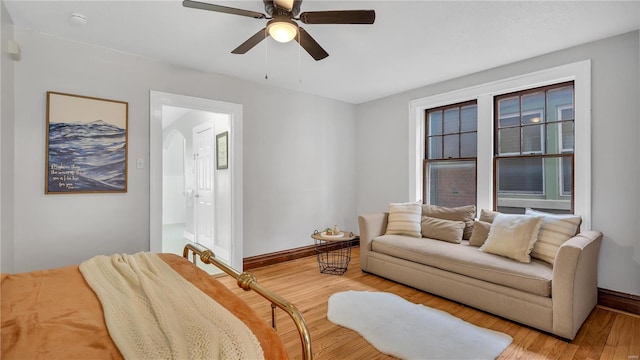 living room with ceiling fan, light wood-style flooring, and baseboards