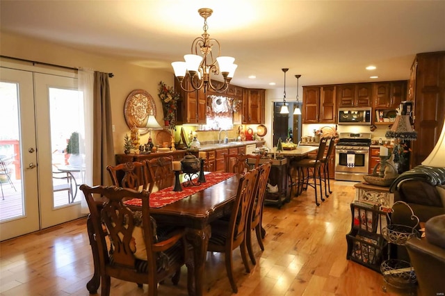 dining area featuring french doors, a healthy amount of sunlight, and light hardwood / wood-style flooring