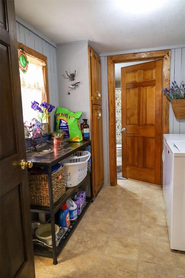 clothes washing area featuring cabinets and washer and dryer