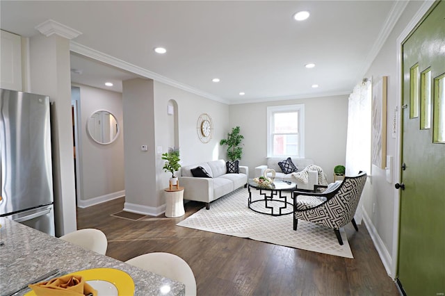 living room featuring baseboards, dark wood finished floors, ornamental molding, recessed lighting, and arched walkways