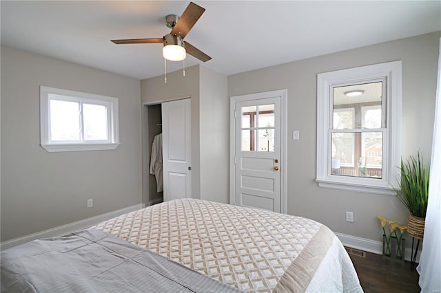 bedroom featuring visible vents, a closet, baseboards, ceiling fan, and dark wood-style flooring