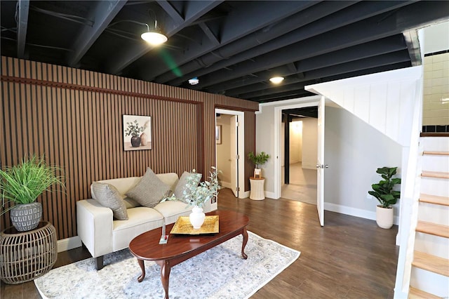 living room with baseboards, stairs, and dark wood-type flooring