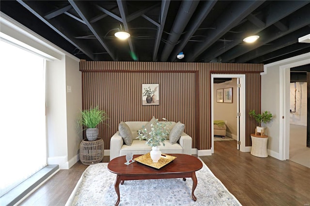 living area with baseboards and wood finished floors