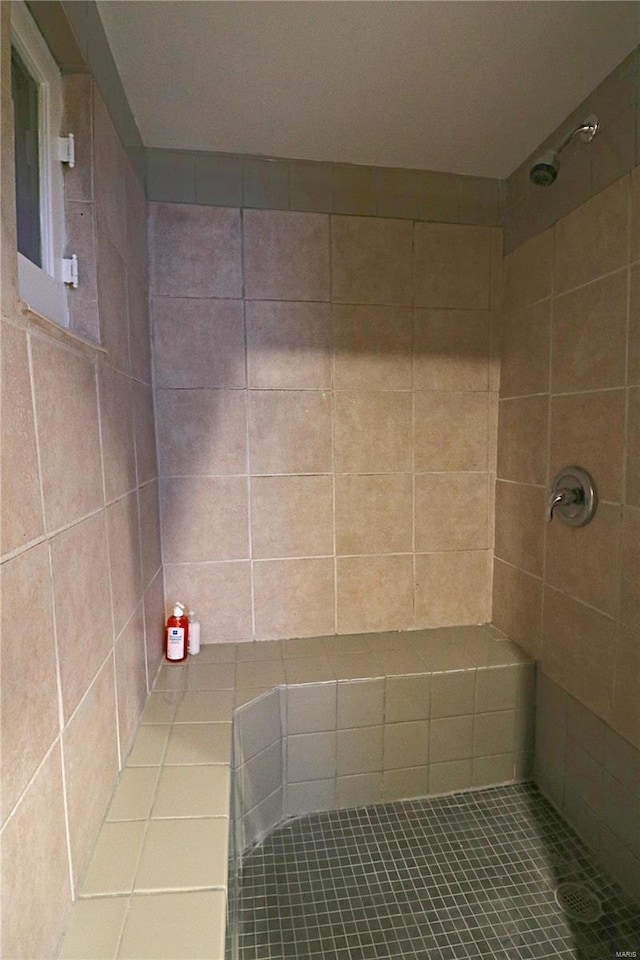 full bath with a tile shower