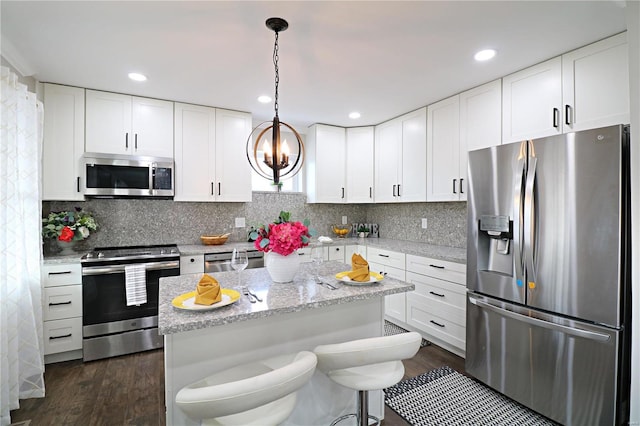 kitchen featuring white cabinets, tasteful backsplash, and stainless steel appliances