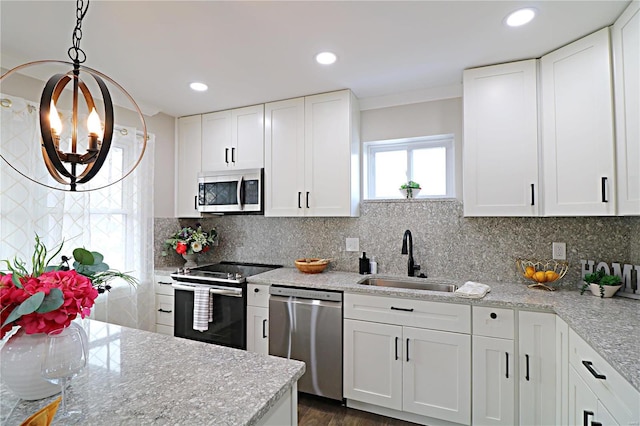 kitchen featuring a sink, tasteful backsplash, appliances with stainless steel finishes, and white cabinets