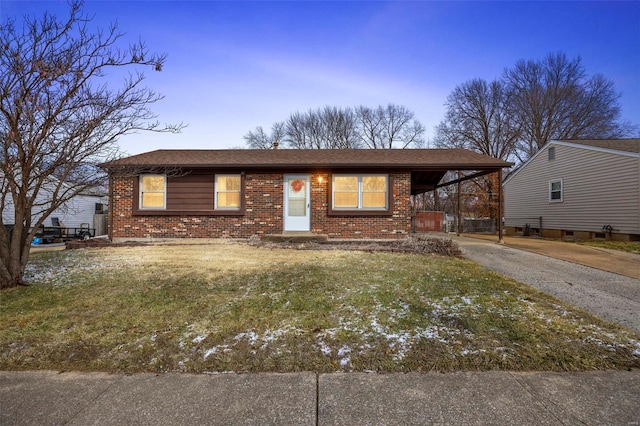 view of front of house featuring driveway, a front lawn, a carport, and brick siding