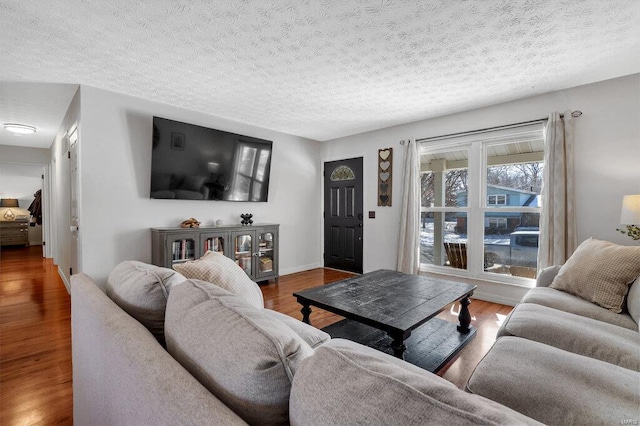 living room featuring dark hardwood / wood-style floors and a textured ceiling