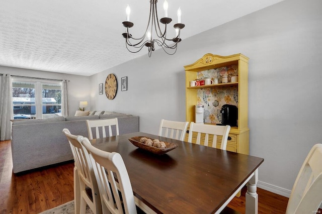 dining room featuring dark hardwood / wood-style flooring and a chandelier