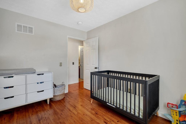 bedroom with hardwood / wood-style flooring