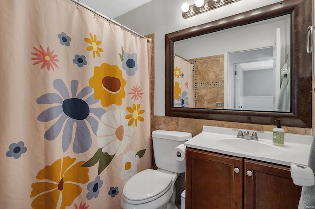 bathroom with vanity, tile walls, a shower with shower curtain, and toilet