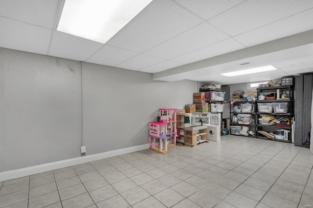 basement with a paneled ceiling